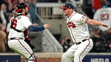 Atlanta Braves relief pitcher Will Smith (51) celebrates with catcher Travis d'Arnaud (16) after the Atlanta Braves beat the Los Angeles Dodgers in game six of the 2021 NLCS to advance to the World Series at Truist Park. 